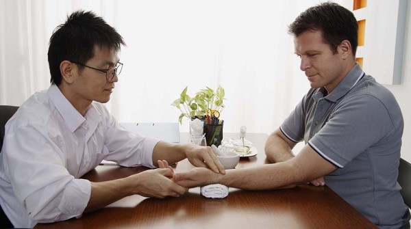 Doctor and patient consultation in osteopathic office